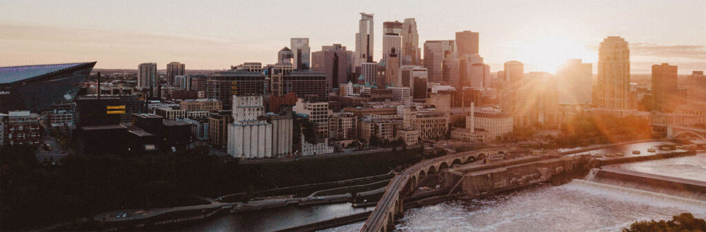 Minneapolis skyline at sunset overlooking the Mississippi river and St. Anthony falls.